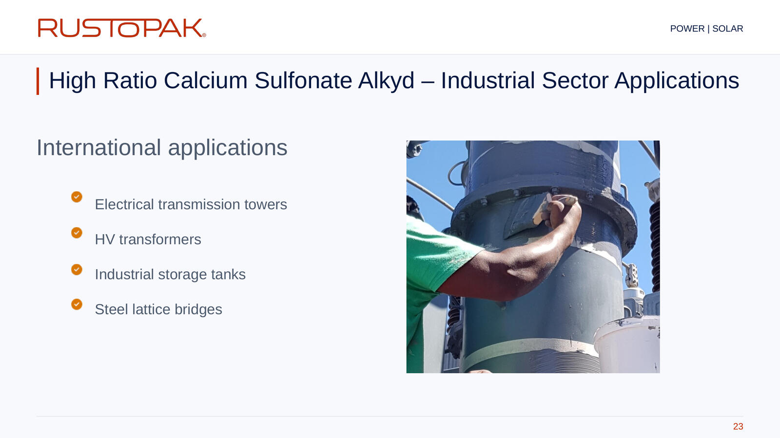 23. High Ratio Calcium Sulfonate Alkyd – Industrial Sector Applications Slide 23: Industrial application list beside a photograph of a worker applying coating by brush to cylindrical steel equipment.
